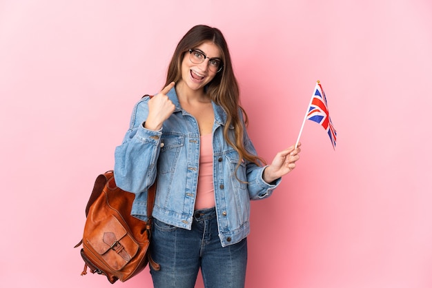 Young woman holding an United Kingdom flag isolated