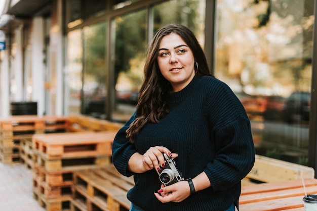 Young woman holding a vintage camera