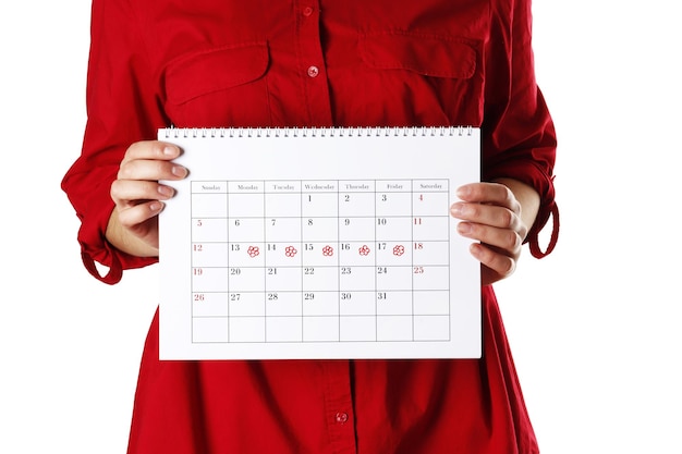 Young woman holding women's period calendar   isolated