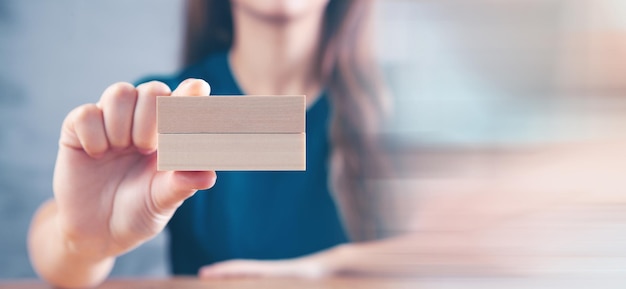 Young woman holding wooden rectangles