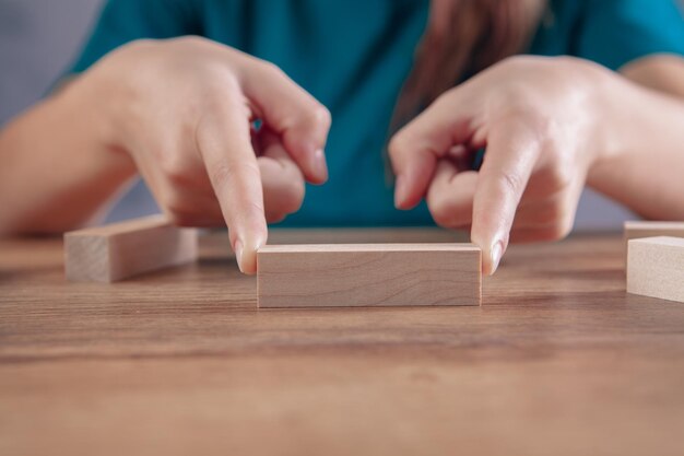 Young woman holding wooden rectangles