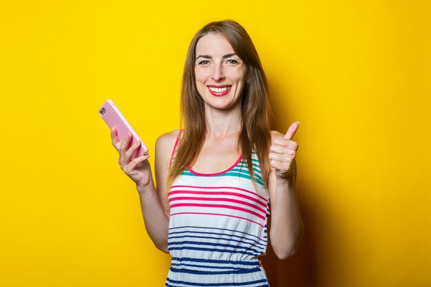 Young woman holds a phone in her hands