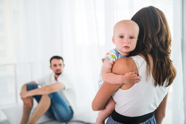 若い女性は小さな子供を保持します