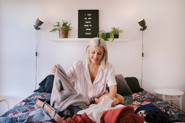 Young woman at home choosing her fashion outfit