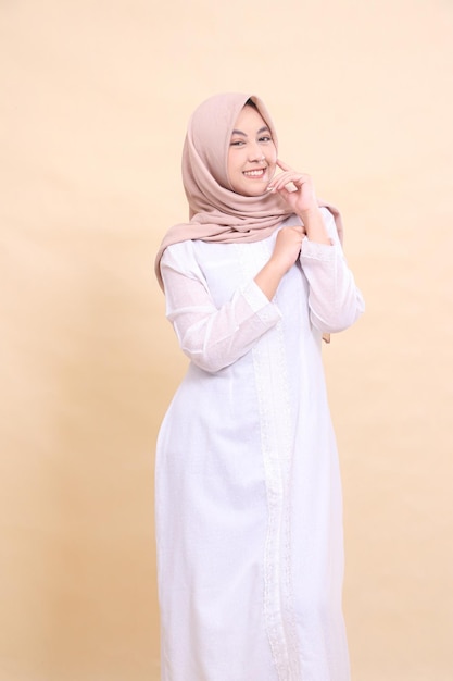 young woman indonesia muslim standing shocked both hands pointing to the top left Fashion pointer bu