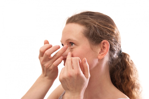 Young woman Inserting a contact lens