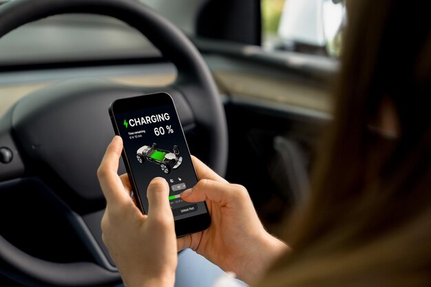 Young woman inside the vehicle checking EV vehicles application Exalt