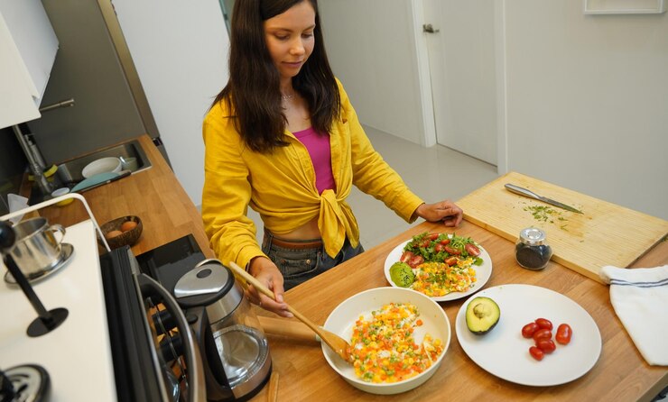Young woman is broadcasting live from workshop how to prepare a vegetarian food