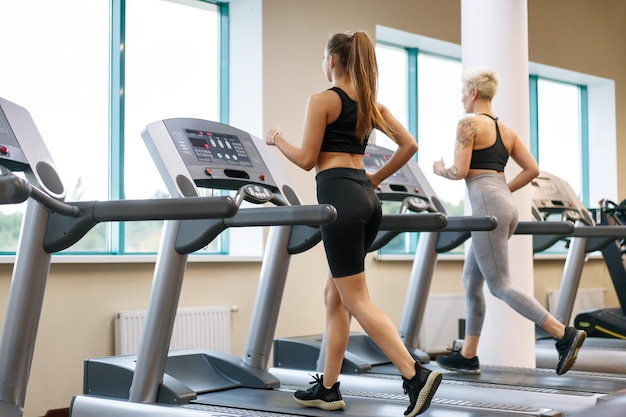 A young woman is doing fitness with a trainer at the gym