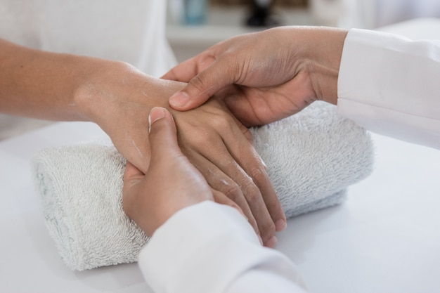 Young woman is getting a hand massage