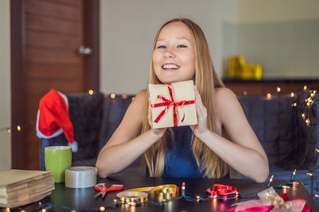 La giovane donna sta imballando i regali