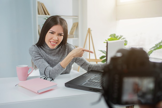 Young woman is pointing on her laptop