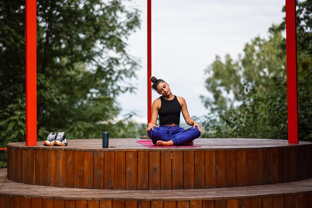 Young woman is practising yoga sitting in the lotus position