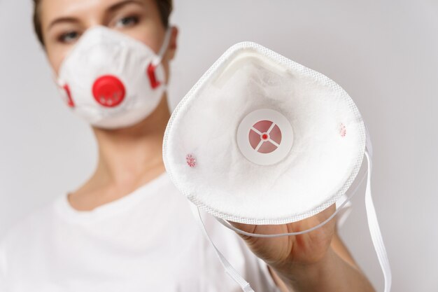 Young woman is put on a face mask on someone for protection against virus