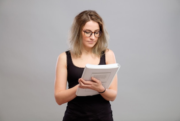 Young woman is reading a book