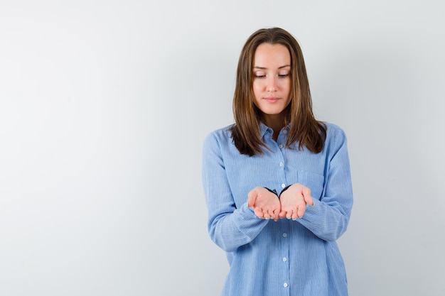 The young woman is showing her handfuls on white background