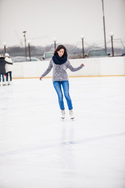 Photo young woman is skating on the rink, winter relax