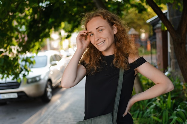 A young woman is smiling and looking at the camera