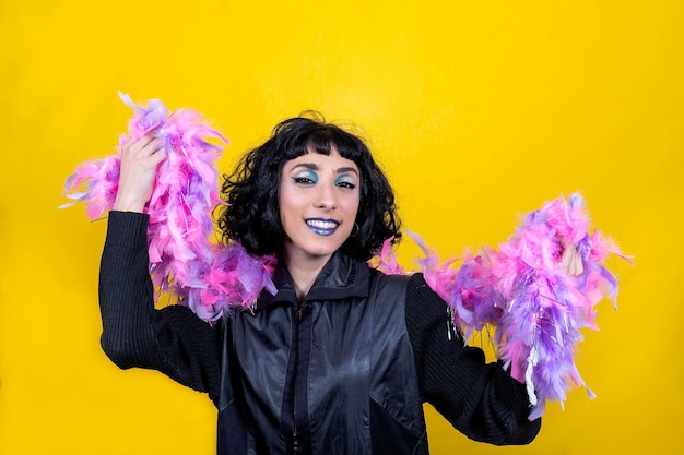 Young woman is wearing a scarf with pink and purple feathers party concept