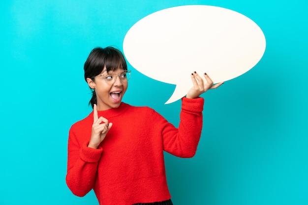 Young woman isolated on blue background holding an empty speech bubble and thinking