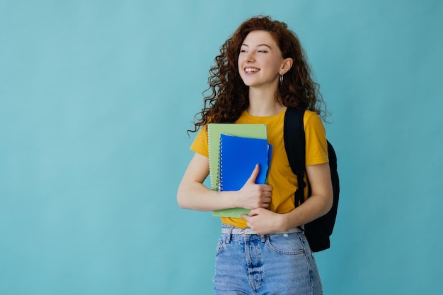 Young woman isolated on blue background with surprise facial expression