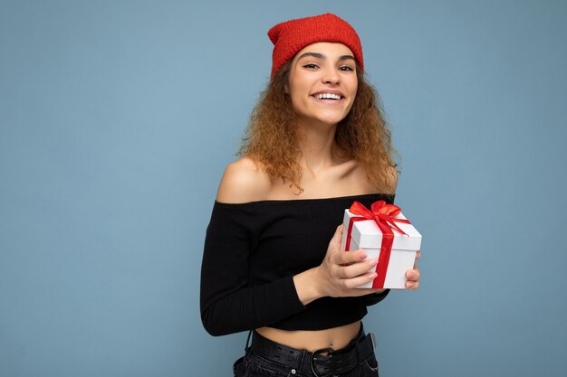 young woman isolated over colourful background wall wearing