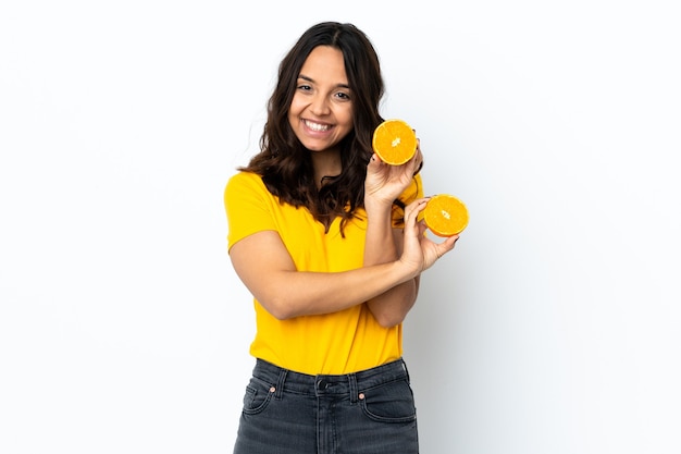 Young woman isolated holding an orange