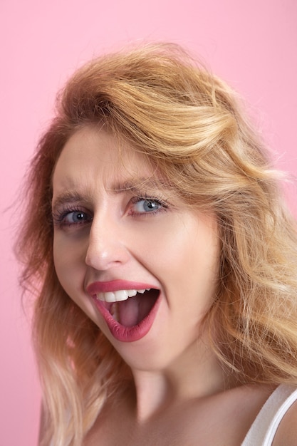 Young woman isolated on pink studio background, copyspace