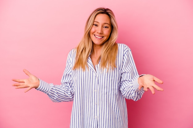 Young woman isolated on pink wall joyful laughing a lot