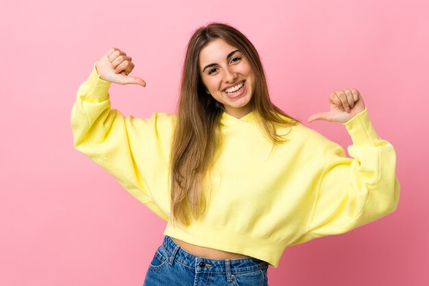 Young woman over isolated pink wall proud and self-satisfied