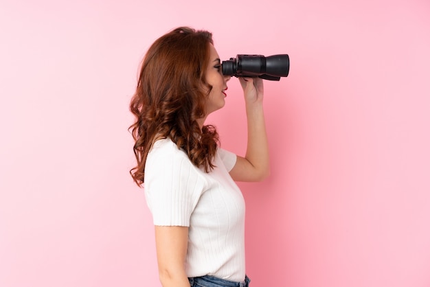 Young woman over isolated pink wall 