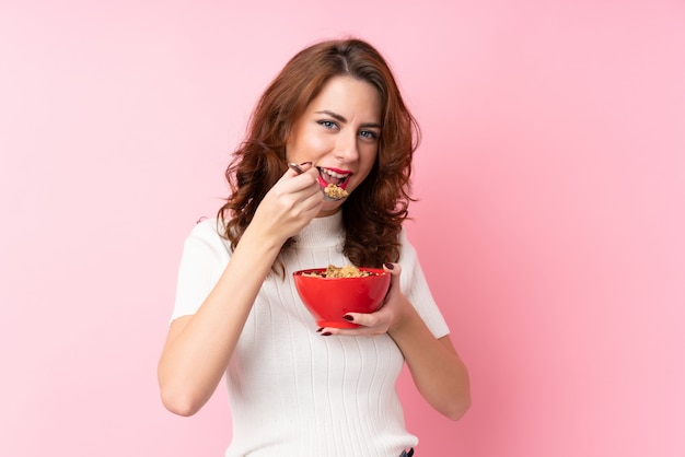 Young woman over isolated pink wall