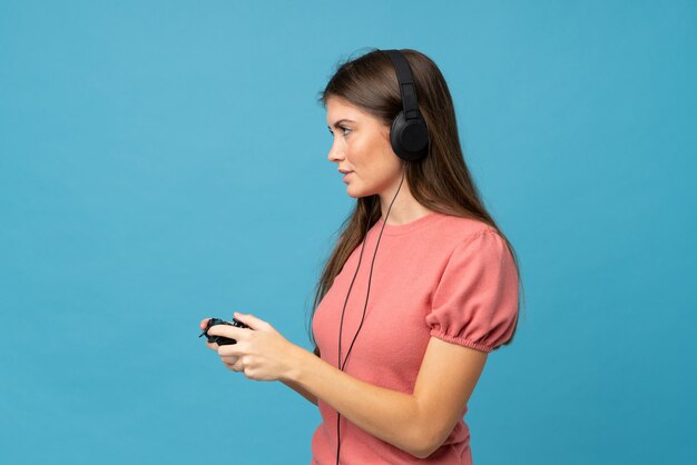 Young woman over isolated  playing at videogames