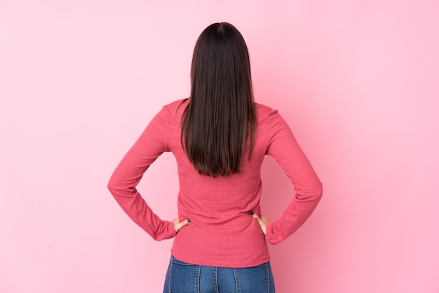 Young woman over isolated wall