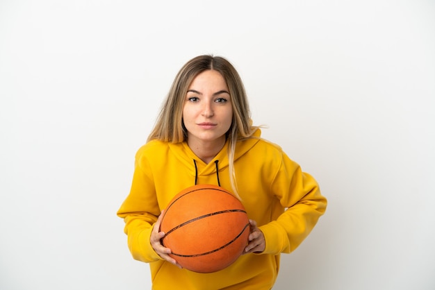 Young woman over isolated white background playing basketball