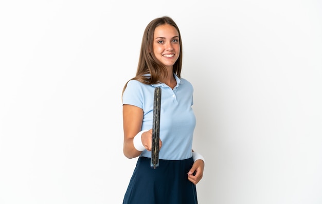 Young woman over isolated white background playing tennis