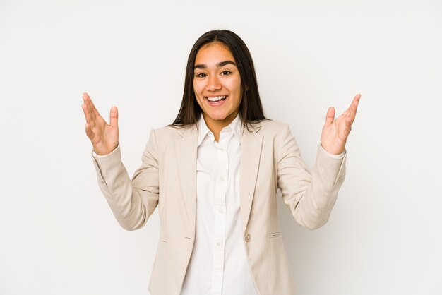 Young woman isolated on a white background receiving a pleasant surprise, excited and raising hands.