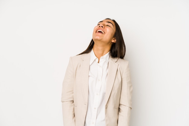 Young woman isolated on a white wall relaxed and happy laughing, neck stretched showing teeth