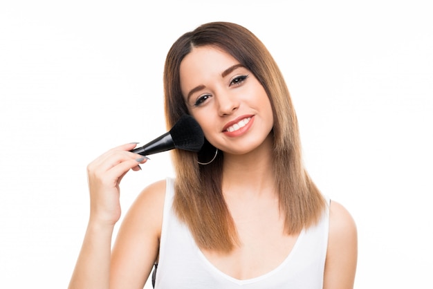 Young woman isolated white  with makeup brush