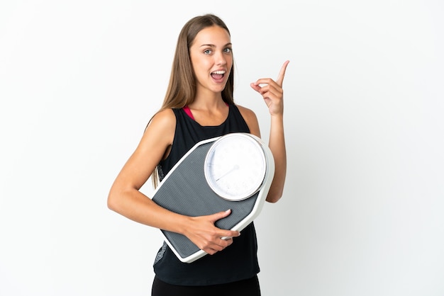 Young woman isolated with weighing machine