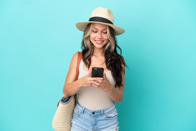 Young woman over isolated yellow background with backpack