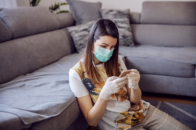 Young woman in isolation having a phone call. Online communication during quarantine. Stay at home.