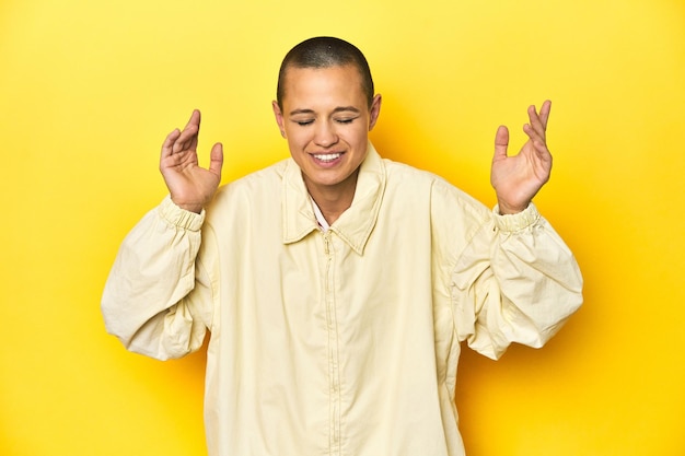 Photo young woman in jacket yellow studio backdrop joyful laughing a lot happiness concept