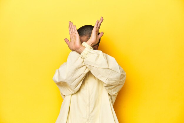 Photo young woman in jacket yellow studio backdrop keeping two arms crossed denial concept