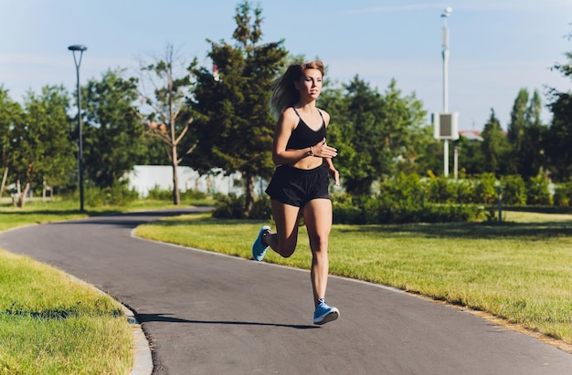 young woman jogging in the park in summer