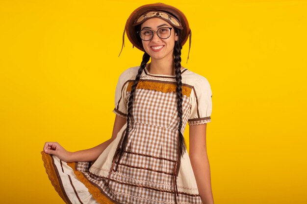 Young woman in a June party dress in a studio photo Festa Junina