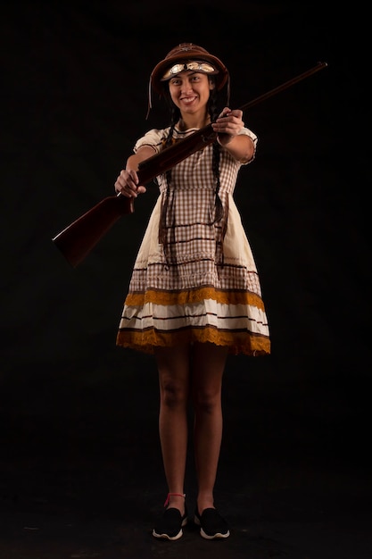 Young woman in a June party dress in a studio photo Festa Junina