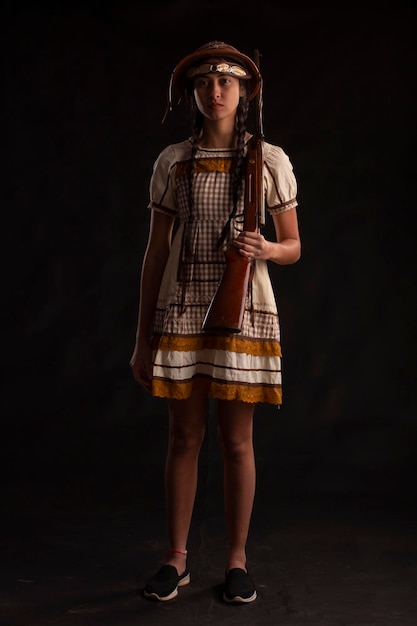 Young woman in a June party dress in a studio photo Festa Junina