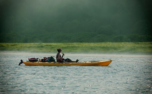 The young woman on kayak on the Lake