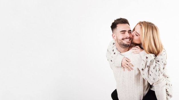 Young woman kissing man in cheek